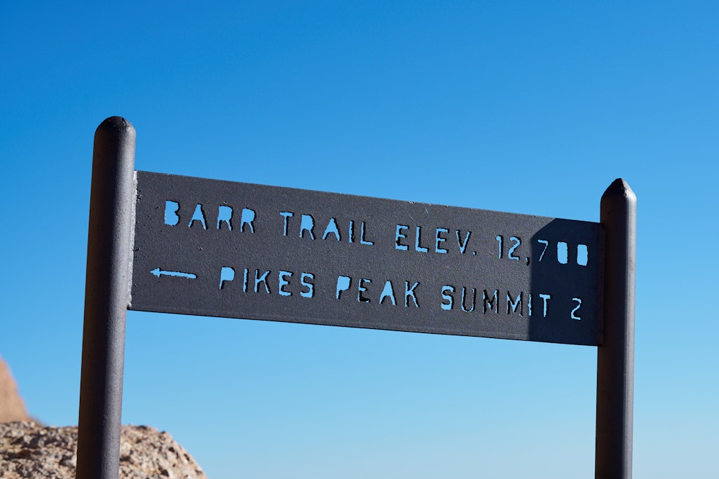 a sign on Barr Trail marking 2 miles to the summit