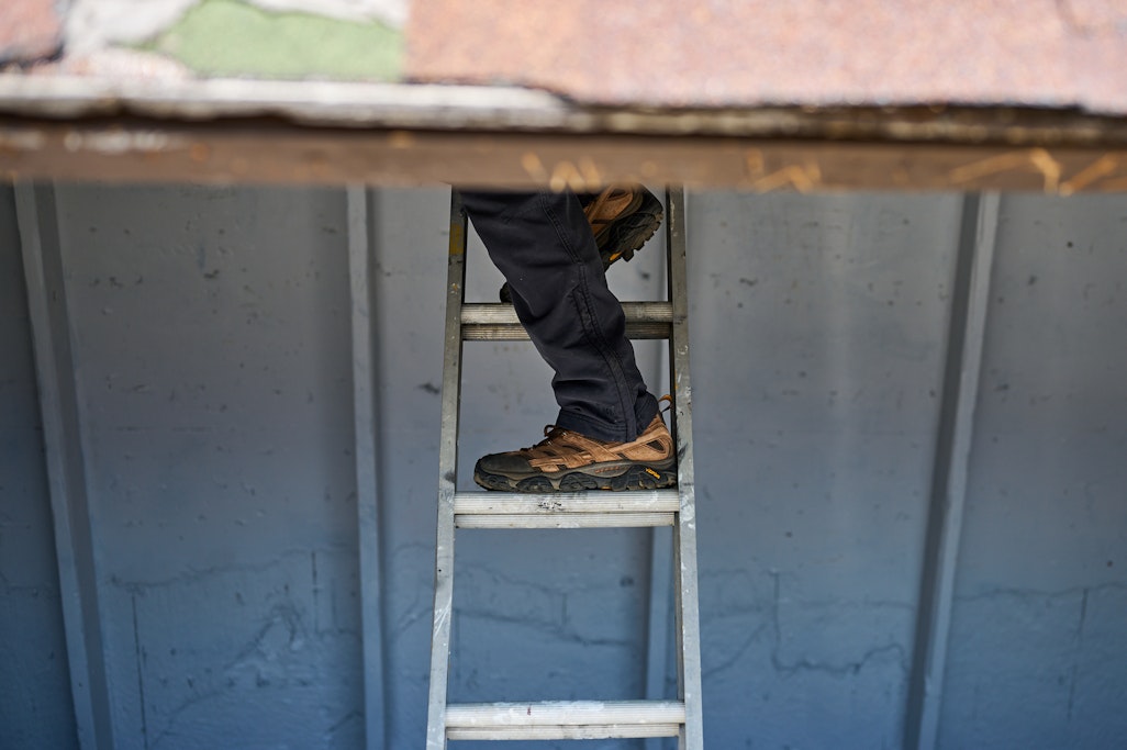 a foot on a ladder inside the A-Frame shelter