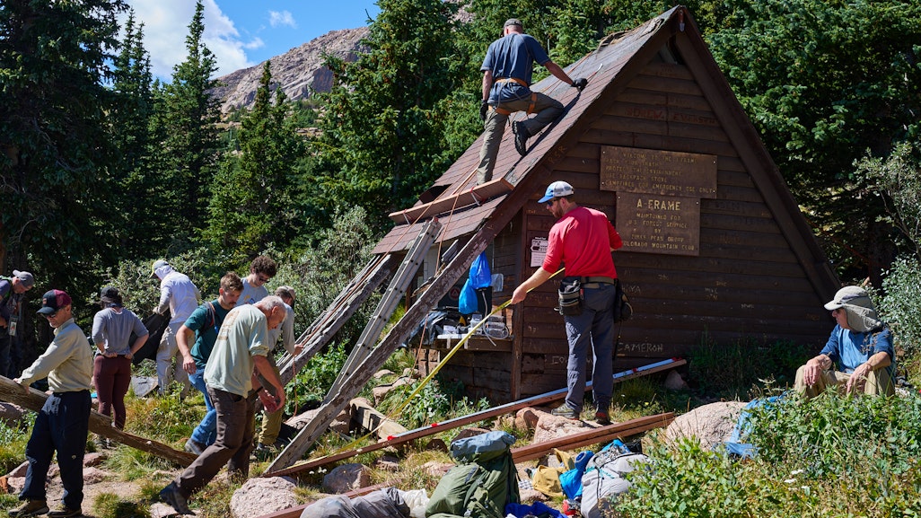 busy people volunteering for Colorado Mountain Club working on a construction scene at the Pikes Peak A-Frame shelter