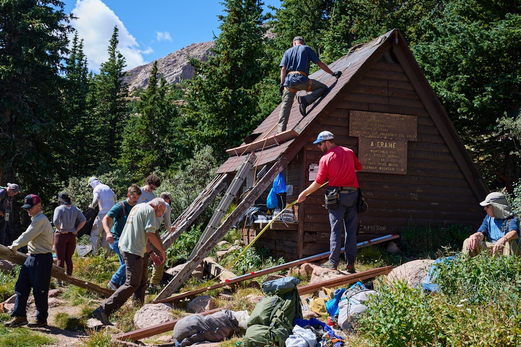 busy people volunteering for Colorado Mountain Club working on a construction scene at the Pikes Peak A-Frame shelter