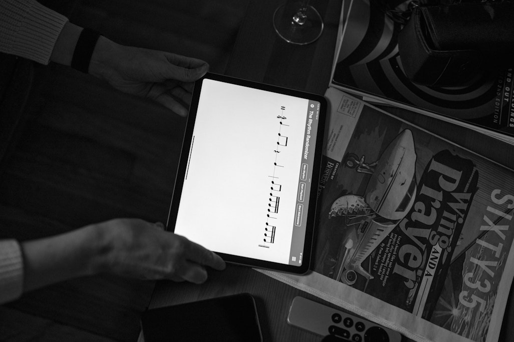 detail of a person reading an iPad tablet on a coffee table to play music