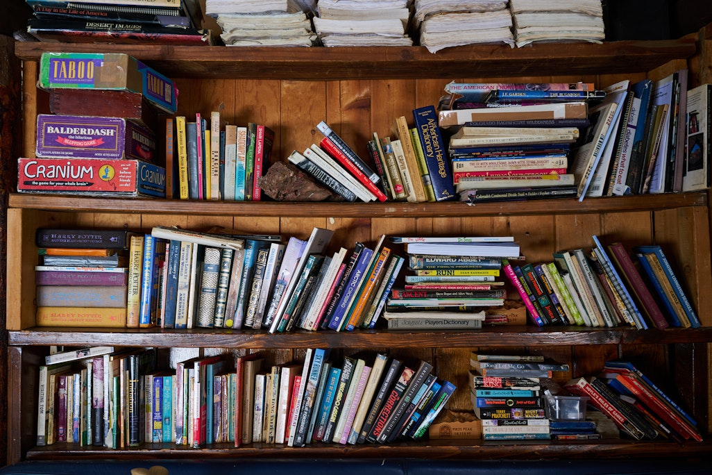 books on interior shelves, straight on view, interior of Barr Camp cabin