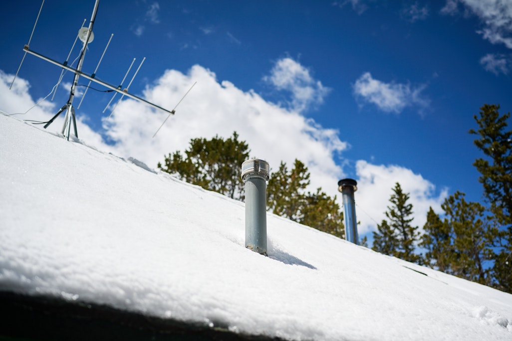chimney and communications antenna at Barr Camp cabin, on a snow-covered roof