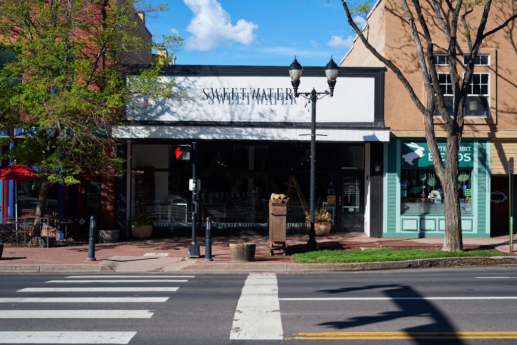 linear street view of shops in Old Colorado City, featuring Sweetwater, a flower shop