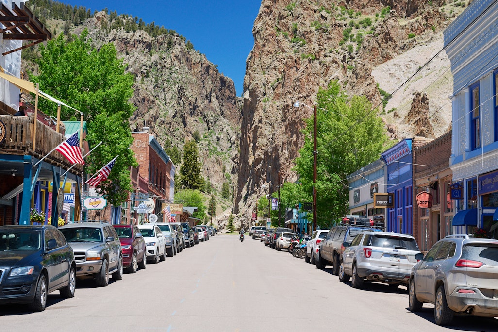 main street in Creede, Colorado, looking up at tall rocks viewed from a commercial center