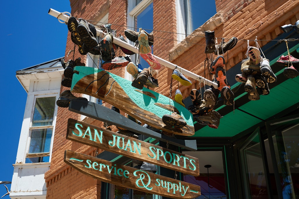 San Juan Sports shop sign, with old running shoes hanging from it by their laces