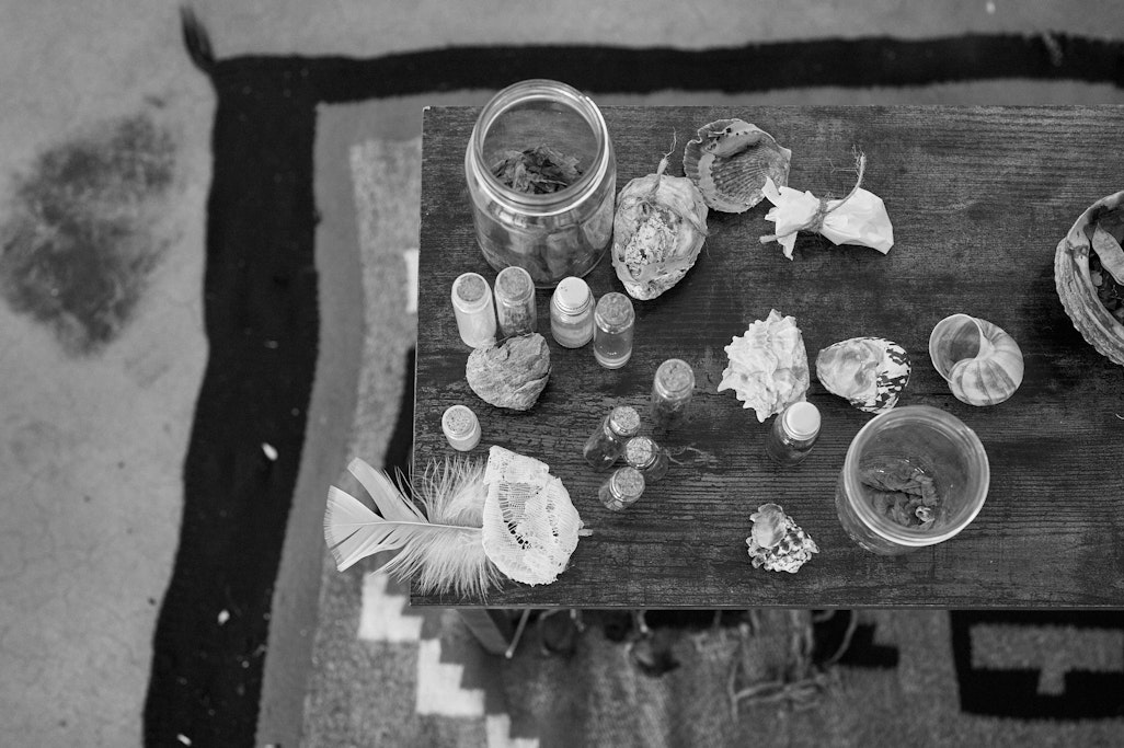 materials to be used as handmade instruments for a live performance, laid out on a wooden table